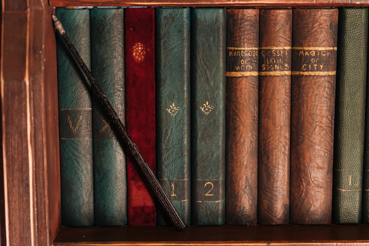 A rustic bookshelf filled with vintage books and a magic wand evokes a sense of fantasy and mystery.